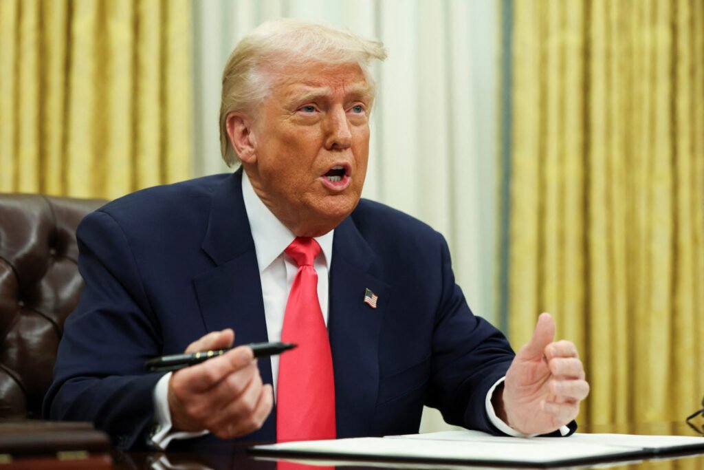 U.S. President Donald Trump signs executive orders in the Oval Office, at the White House in Washington, D.C.